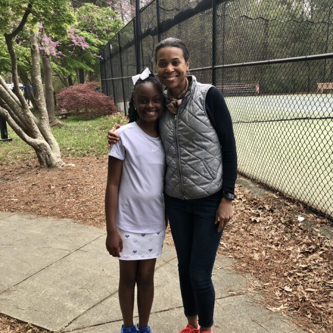 Helen coaching Avery for her tennis match.